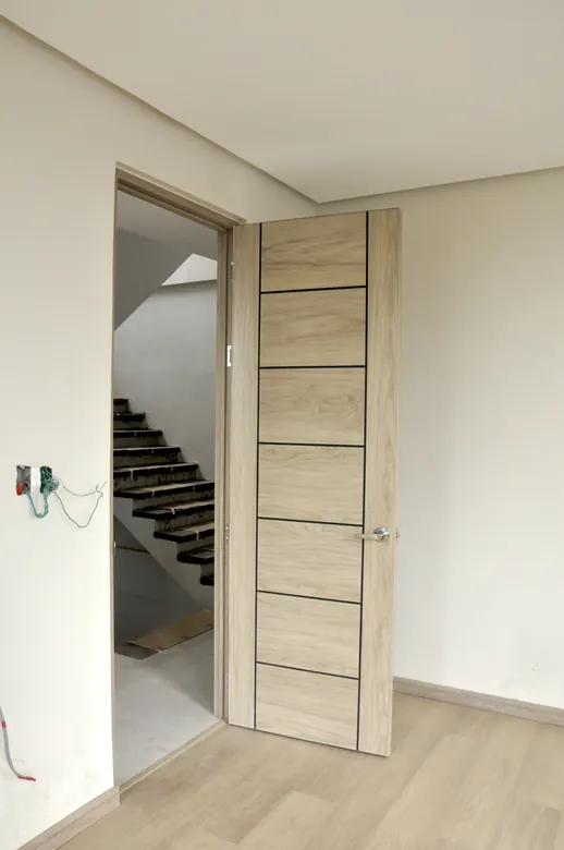 Pale oak Polydoor beside an open staircase