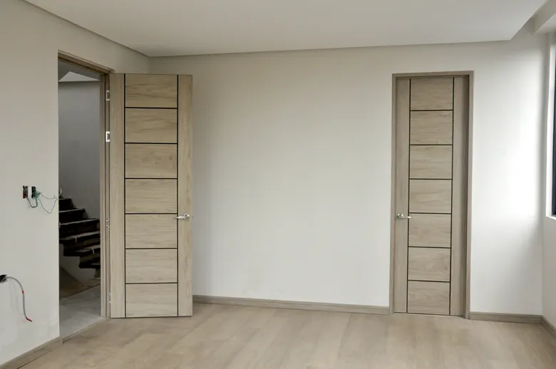 Two pale grey Polydoors in a finished bedroom
