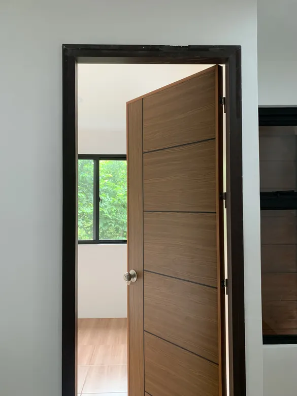 Polydoor opened onto a bright, plant-filled room