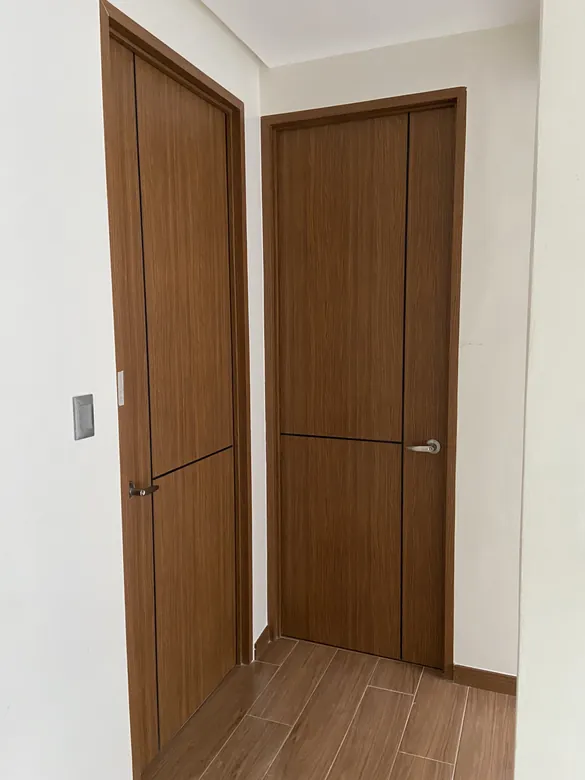 Two walnut Polydoors along a hallway