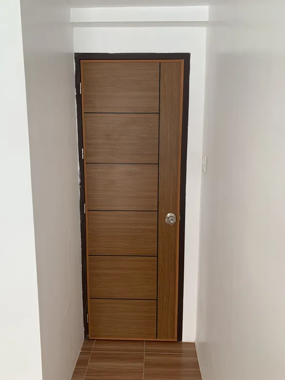 Polydoor at the end of a minimalist hallway